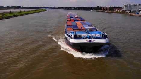 Aerial-Parallax-Round-Belicha-Cargo-Ship-Approaching-Bridge-On-River-Noord