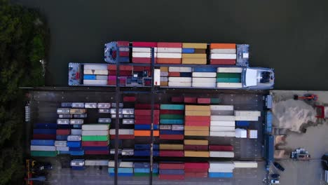 Aerial-Top-Down-View-Of-Gantry-Crane-Moving-Cargo-Containers-At-Loading-Facility