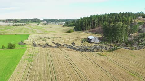 Large-landslide-near-NCC-operated-open-pit-construction-rock-quarry,-dirt-road-and-agricultural-field-and-barn-destroyed-due-to-shifting-soil