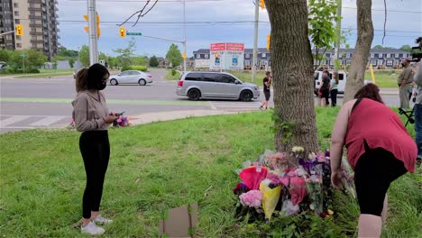 Bystanders-place-flowers-on-a-makeshift-memorial-near-the-scene-of-a-terror-attack