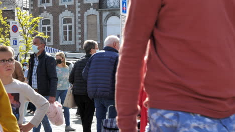 People-with-face-masks-walking-at-city-market-in-Tongeren