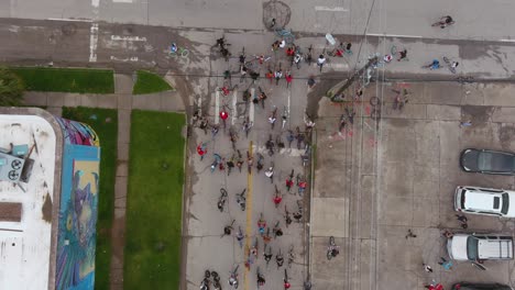 4k-Birds-eye-view-of-bicyclists-riding-through-streets