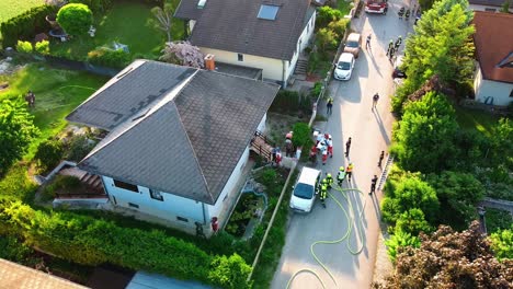 AERIAL---Firefighters-at-fire-in-a-house-in-Oberwaltersdorf,-Austria