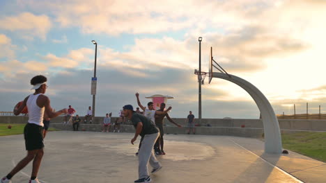 Slow-pan-left-shot-of-guys-play-hoops,-Imperial-Beach,-California