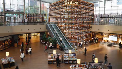 Modern-space-of-Starfield-Library-with-visitors-in-Coex-Mall---Tourist's-attraction-landmark-of-Seoul---establishing-wide-shot-and-tilt-down-timelapse