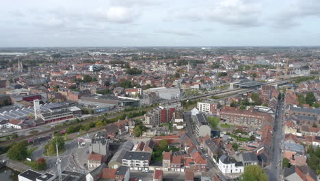 Roeselare-City-Aerial-Approach,-Train-Entering-the-Station