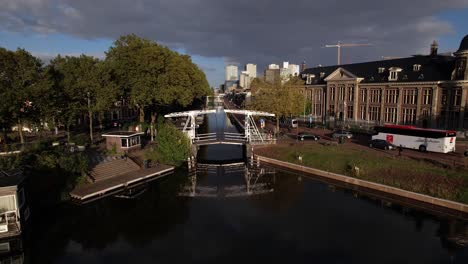 Aerial-showing-Muntgebouw-museum-in-Utrecht-with-small-draw-bridge-over-the-canal-in-front-on-a-bright-sunny-day-with-cloud-formation-in-the-background