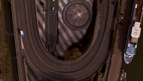 Slow-forward-top-down-aerial-reveal-of-transit-roundabout-intersection-eye-near-Utrecht