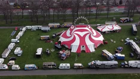 Planet-circus-daredevil-entertainment-colourful-swirl-tent-and-caravan-trailer-ring-aerial-view-rotating-left-shot