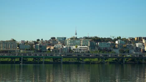 Namsan-Tower-or-N-Seoul-tower-over-Yongsan-district-from-Han-river,-famous-landmark-of-South-Korea-on-beautiful-day