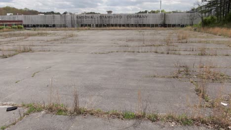 Drone-Footage-Panning-Up-and-Moving-Towards-an-Abandoned-National-Standard-Factory