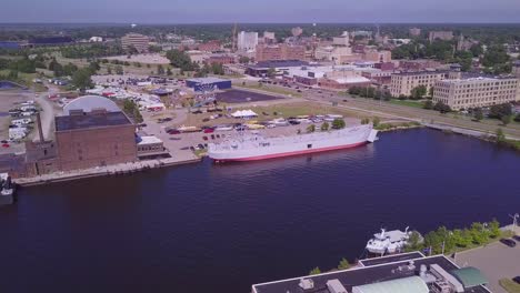 Forward-aerial-of-naval-ship-USS-LST-393-on-sunny-day-in-Muskegon,-MI