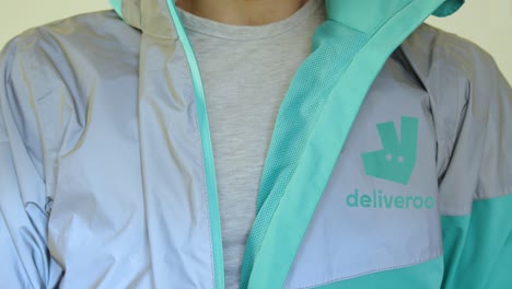 Male-Deliveroo-rider-dress-up-ready-to-deliver-food-to-customers-and-clients