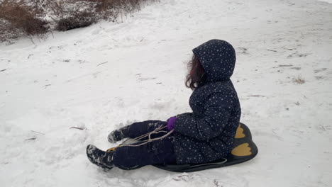 Young-Girl-Sleds-Down-Hill-In-Central-Park-In-New-York-City
