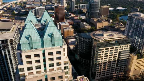 4K-Cinematic-aerial-video-orbiting-clip-around-the-SunTrust-building-reveals-the-Orange-ave-strip-in-downtown-Orlando,-Florida-during-sunrise