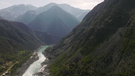 Aerial-shot-of-terraced-fields-and-river-flowing-in-the-valley-in-swat-valley