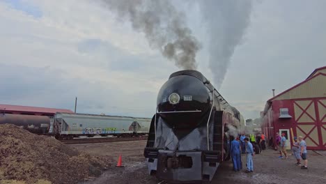 A-Close-Up-Look-at-an-Antique-Steam-Engine-as-it-Gets-Ready-for-a-Day-Work-as-Tourist-Look-On