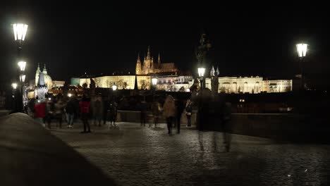 Night-Time-Lapse-with-Tourists-on-Famous-Charles-Bridge-in-Prague