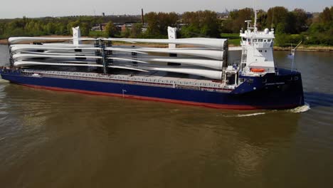 Aerial-Starboard-View-Of-Symphony-Provider-Cargo-Ship-Transporting-Transporting-Wind-Turbine-Propeller-Blades-Along-Oude-Maas