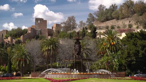 Blick-Auf-Den-Brunnen-Mit-Malaga-Alcazar-In-Der-Ferne-In-Zeitlupe