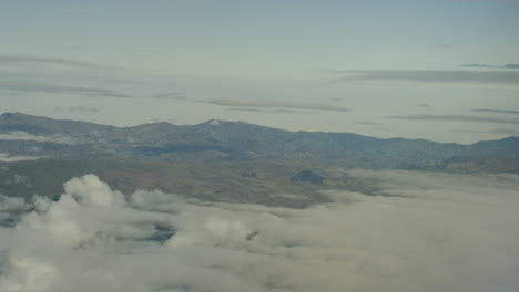 Aerial-view-from-plane,-clouds-and-mountains
