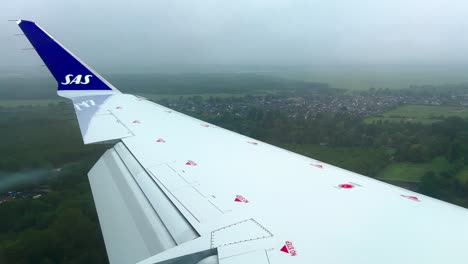 Sas-Bombardier-CRJ-commercial-jet-airplane-wing-approaching-Copenhagen-airport-in-Denmark