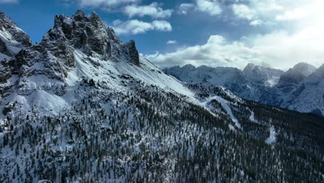 Drone-wide-Aerial-view-of-mountains-with-snow-in-winter,-Dolomites-area-in-the-north-east-of-Italy
