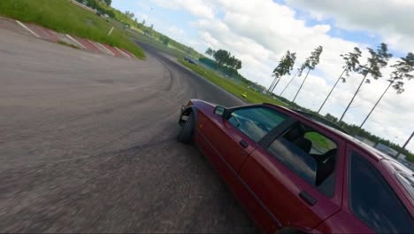 Drifting-car-filmed-by-FPV-drone-in-Lidköping,-Sweden