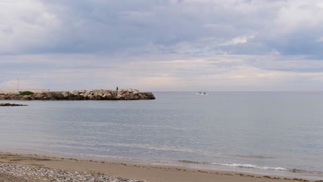 wide-shot-of-the-Mediterranean-sea-in-Malaga-Spain-with-two-boats-in-the-background
