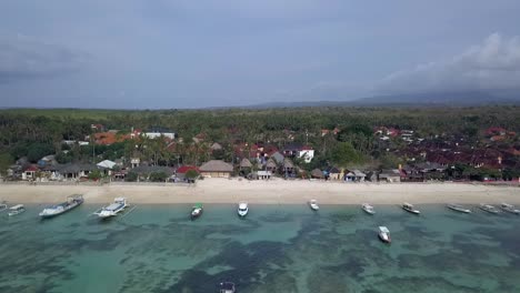 Unbelievable-aerial-view-flight-overfly-drone-footage-offshore-over-the-reef-to-the-local-boats-at-white-sand-beach-at-Mushroom-Bay-lembongan
