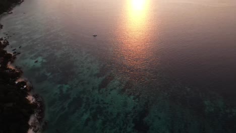 Aerial-Tilt-Up-Over-Koh-Lipe-To-Reveal-Golden-Orange-Sunset-Over-Strait-of-Malacca