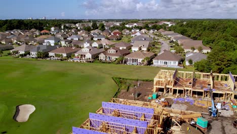 aerial-pullout-new-home-construction-at-barefoot-landing-in-north-myrtle-beach-sc,-south-carolina