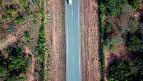 Overhead-View-Of-A-Vehicle-Driving-Through-Two-lane-Road-In-Africa