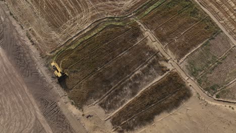 Overhead-Aerial-View-Of-A-Combine-Harvester-Working-In-Punjab-Field-In-Pakistan