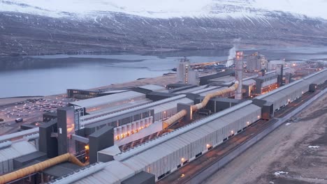 Massive-aluminium-factory-on-shore-of-Icelandic-fjord,-aerial