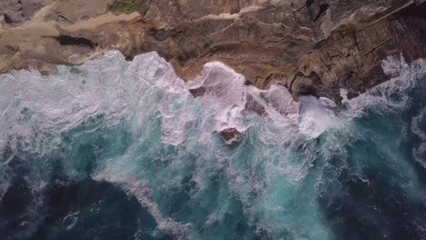 Top-down-aerial-view-of-rock-beach-deep-blue-ocean-waves-amazing-and-beautiful-video-tropical-sea-in-Australia-at-Pacific-Ocean