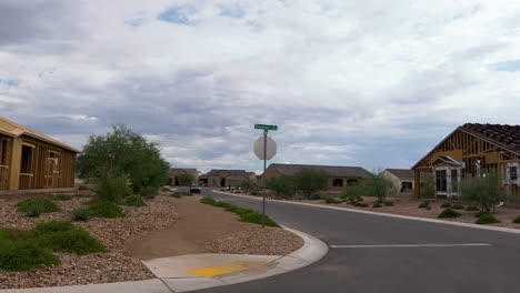 Long-street-with-many-new-homes-and-houses-under-construction-in-Quail-Creek,-a-Southern-Arizona-retirement-community