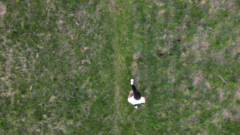 Birds-Eye-Aerial-View-of-Young-Man-Doing-Somersault-From-Standing-Position-in-Outdoors,-Top-Down-Drone-Slow-Motion-Shot