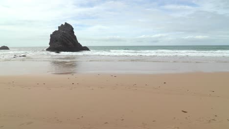 Isolated-Black-Rock-Near-the-Beach-of-Gruta-da-Adraga-Mountain-Range-in-Portugal