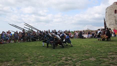 Pikeman-infantry-reenactment-show-charge-for-horse-defence-position-on-living-history-festival-in-Tenczyn-Castle,-Poland