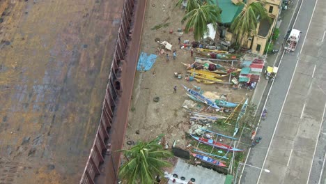 Aerial-view-of-huge-ship-stuck-on-the-seashore-after-Typhoon-Rolly-hit-Puerto-Galera,-Philippines