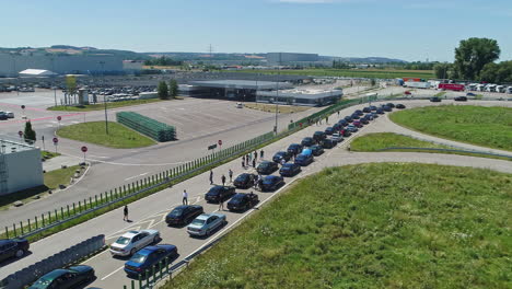 BMW-sedans-lined-up-on-a-racetrack-for-a-celebration-event-for-the-50th-anniversary-of-the-M-series---aerial-view