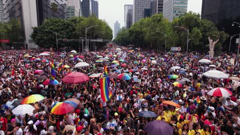 Aerial-view-over-a-large-crowd-of-people-celebrating-pride-on-the-streets-of-Mexico-city---rising,-drone-shot
