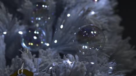 White-Christmas-Tree-in-dark-environment-with-baubles-and-more-decoration