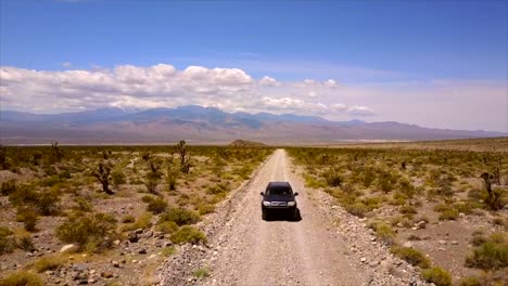 Car-driving-down-desert-trail-in-Nevada-3