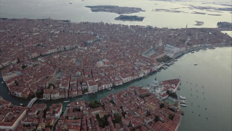 Wide-aerial-ascending-shot-of-San-Marco-area-from-above-at-dusk,-Venice,-Italy