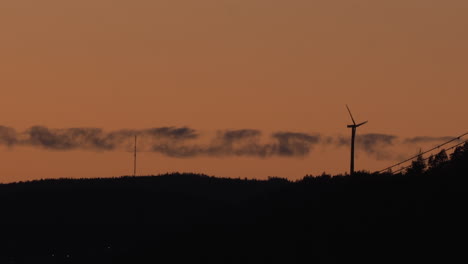 Wind-power-generator-turbine,-at-a-sunny-evening-dusk,-in-Hoga-Kusten,-Vasternorrland,-Sweden