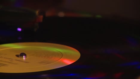 Vinyl-record-spinning-on-turntable-with-reflecting-lights