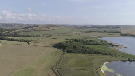 Aerial-shot-tracking-from-right-to-left-revealing-the-fleet-lagoon-and-Swannery-between-Chesil-beach-and-the-village-of-Abbotsbury