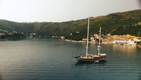 Aerial-circle-shot-of-a-sailboat-in-Croatia,-while-sailing-in-a-lake